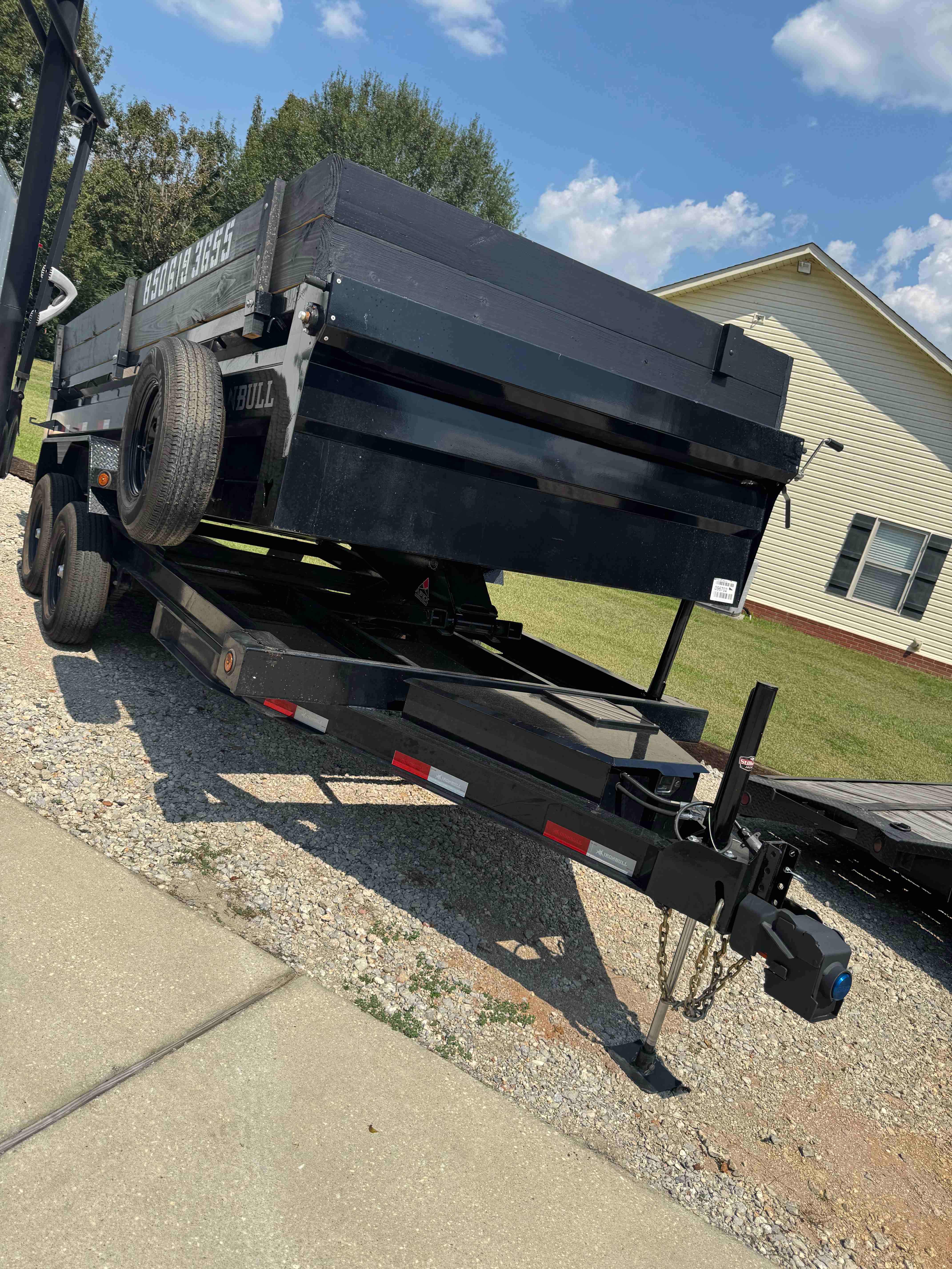 Ironbull 7x16 Dump Trailer - Tilted Position demonstrating hydraulic dump functionality for easy unloading